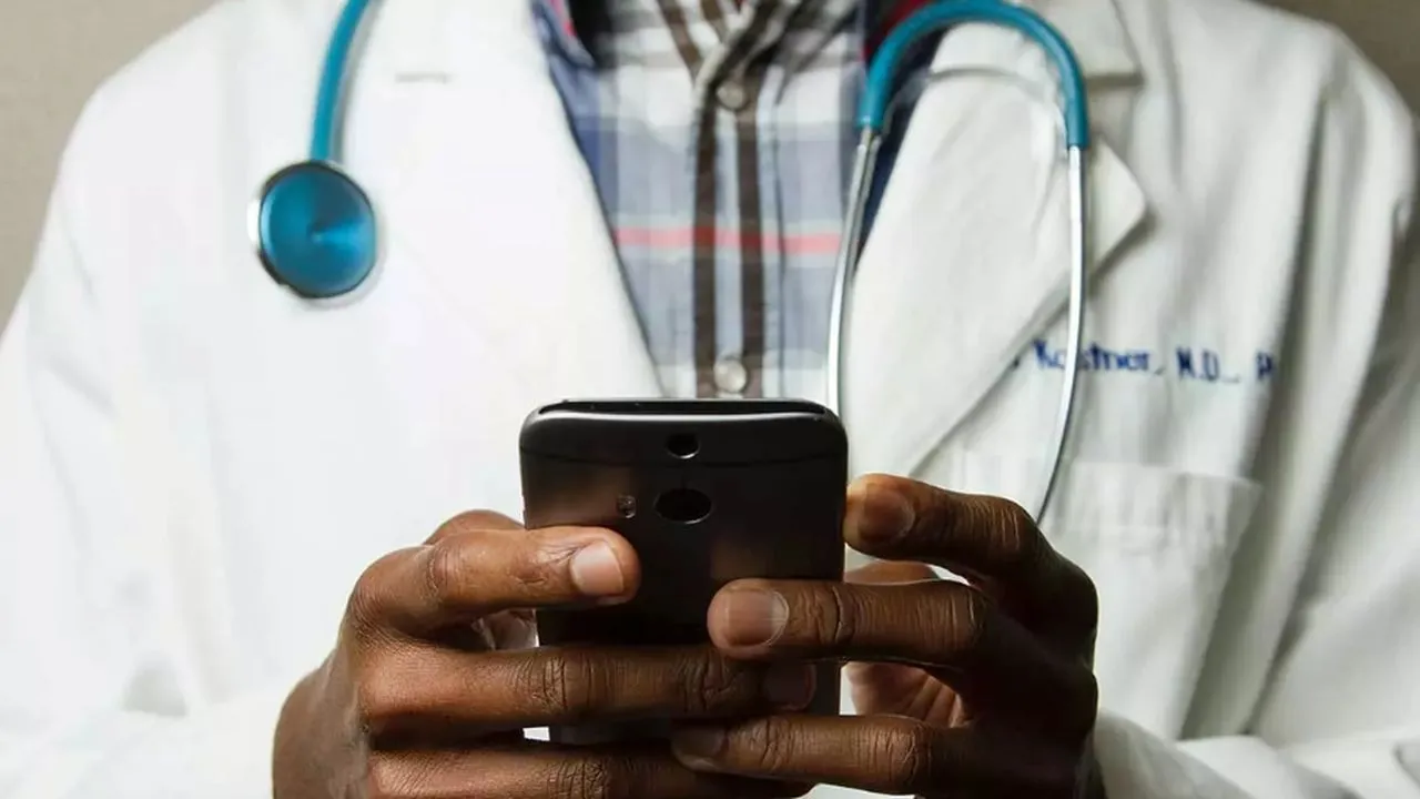 Doctor-sujetando-telefono-movil